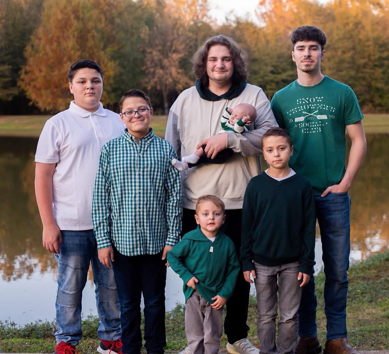 The seven Griffin sons together beside a lake in an earlier family photograph